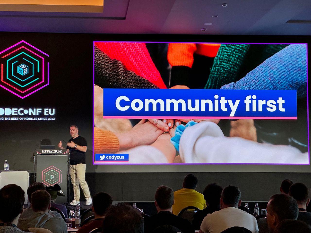 Cody presenting a community first slide at nodeconf eu