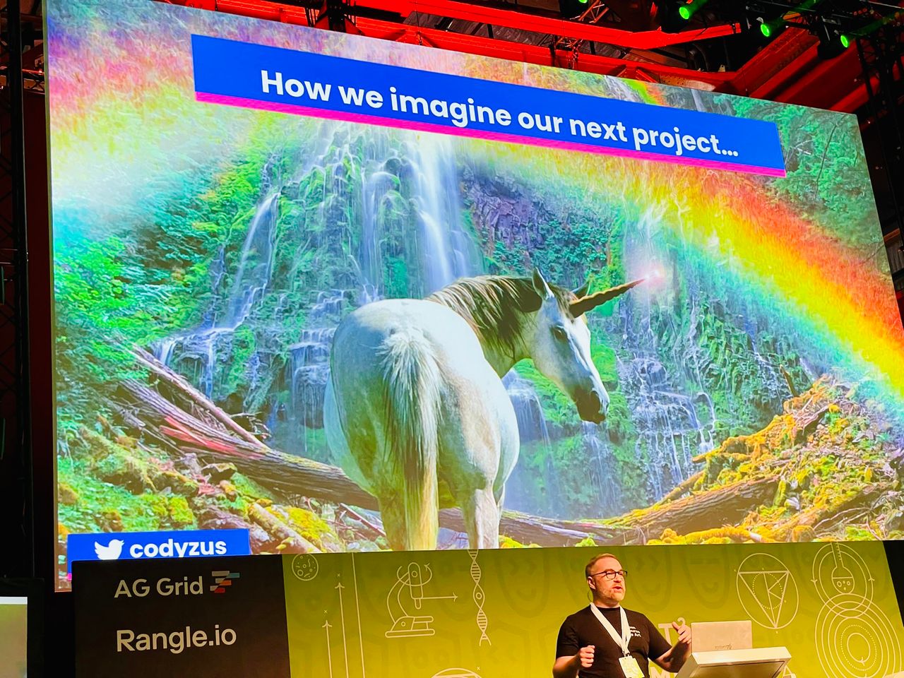 Cody presenting a slide about unicorns at react summit