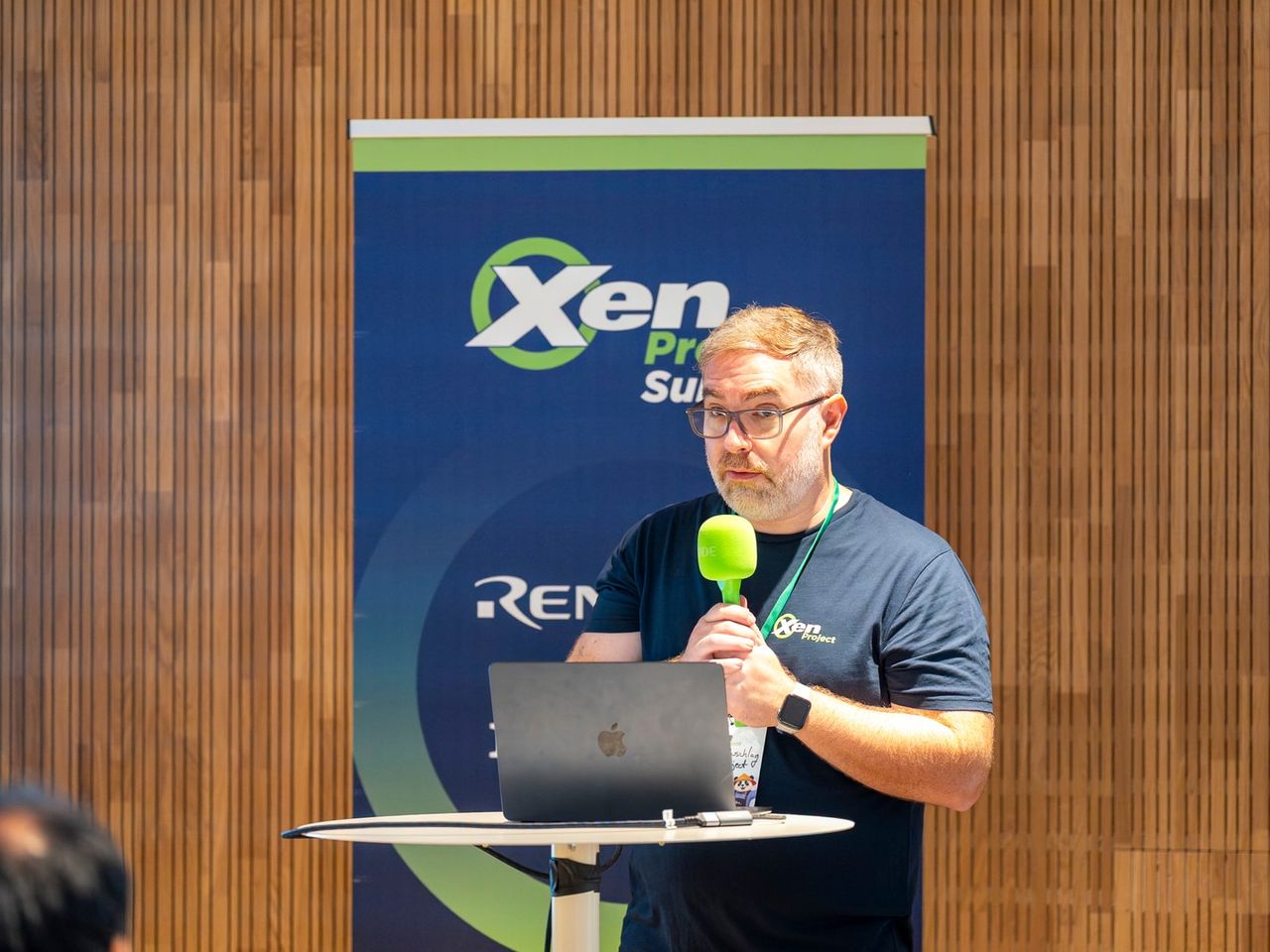 Cody speaking with a microphone at xen summit 2026